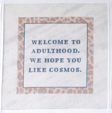 message on fabric with decorative border, displayed on a flat surface.